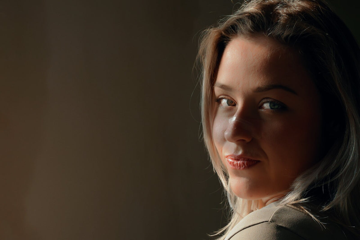 Woman wearing a transparent Resty nasal strip indoors