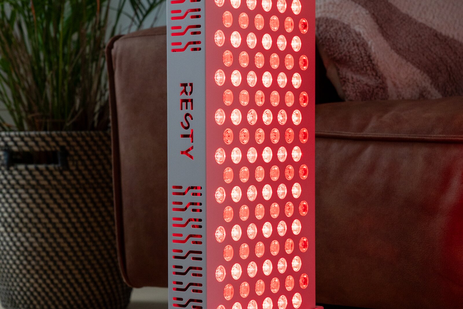Woman using a Resty MARS red light panel at home