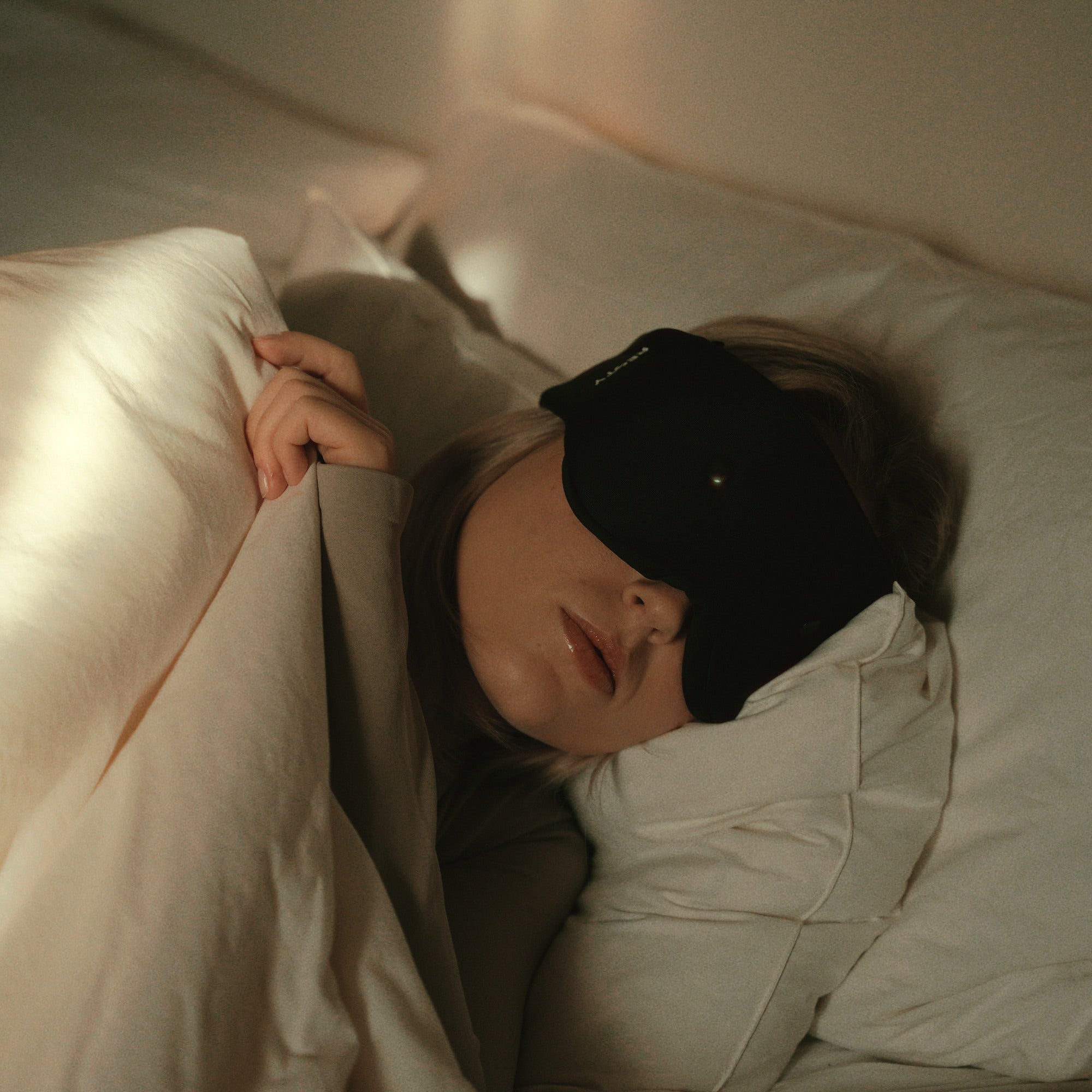 Resty sleep mask worn while sleeping in bed at night