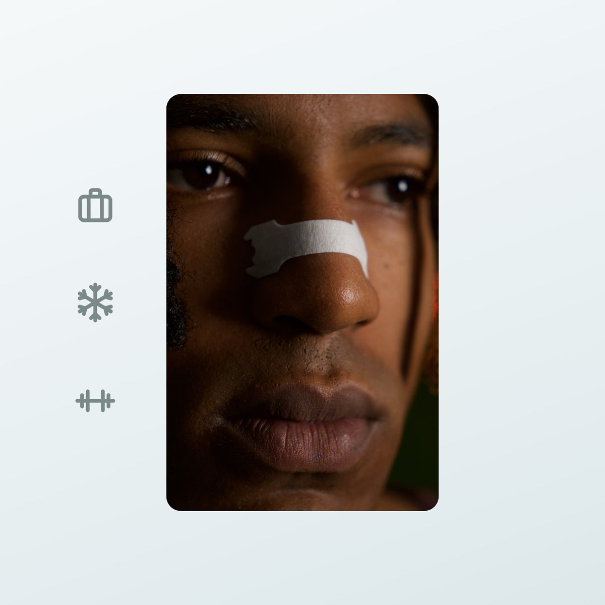 Real low-light photo of a man wearing the white Minty strip on a winter evening, next to icons for on the go, outdoors and sport.