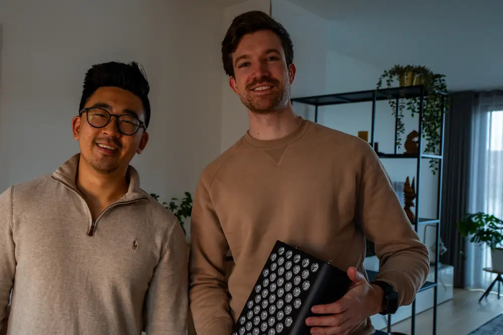 The people behind Resty next to a MARS red light panel