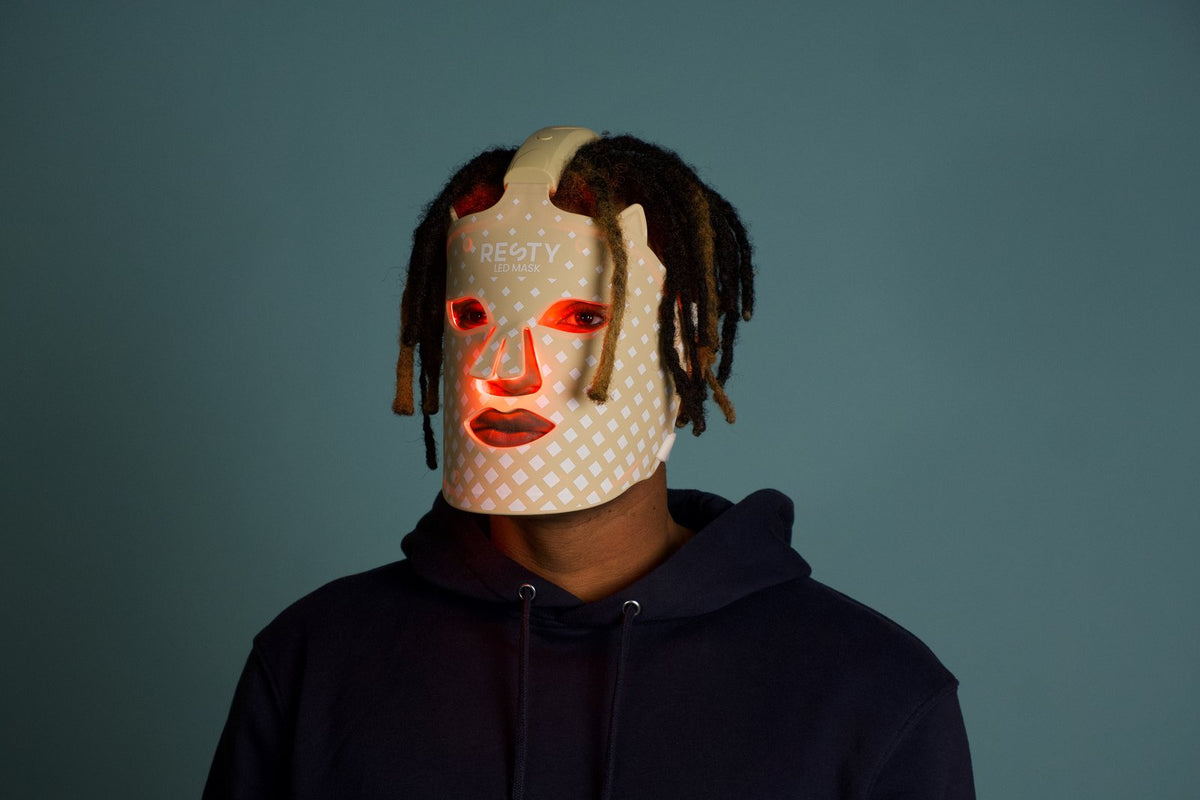 Man wearing a glowing Resty LED face mask