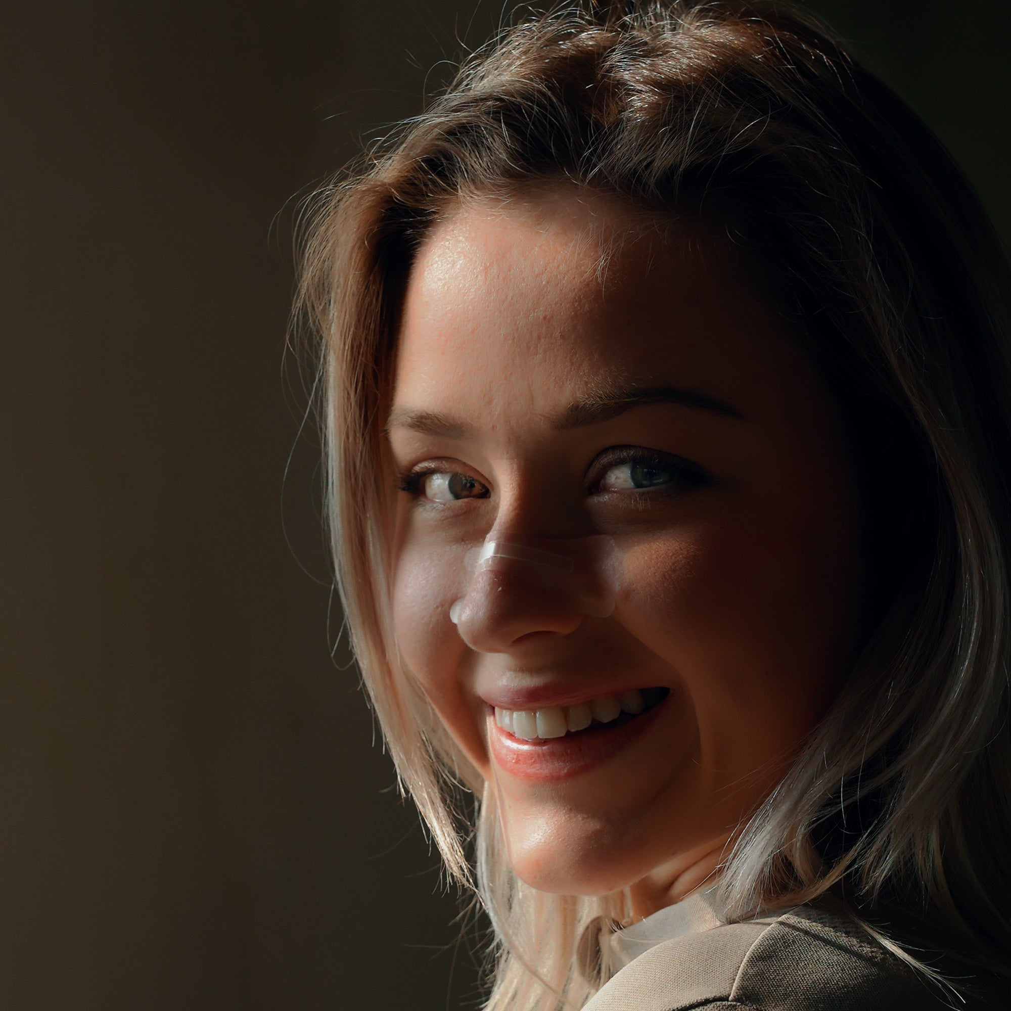 Close-up of a smiling real wearer with the transparent Resty nasal strip