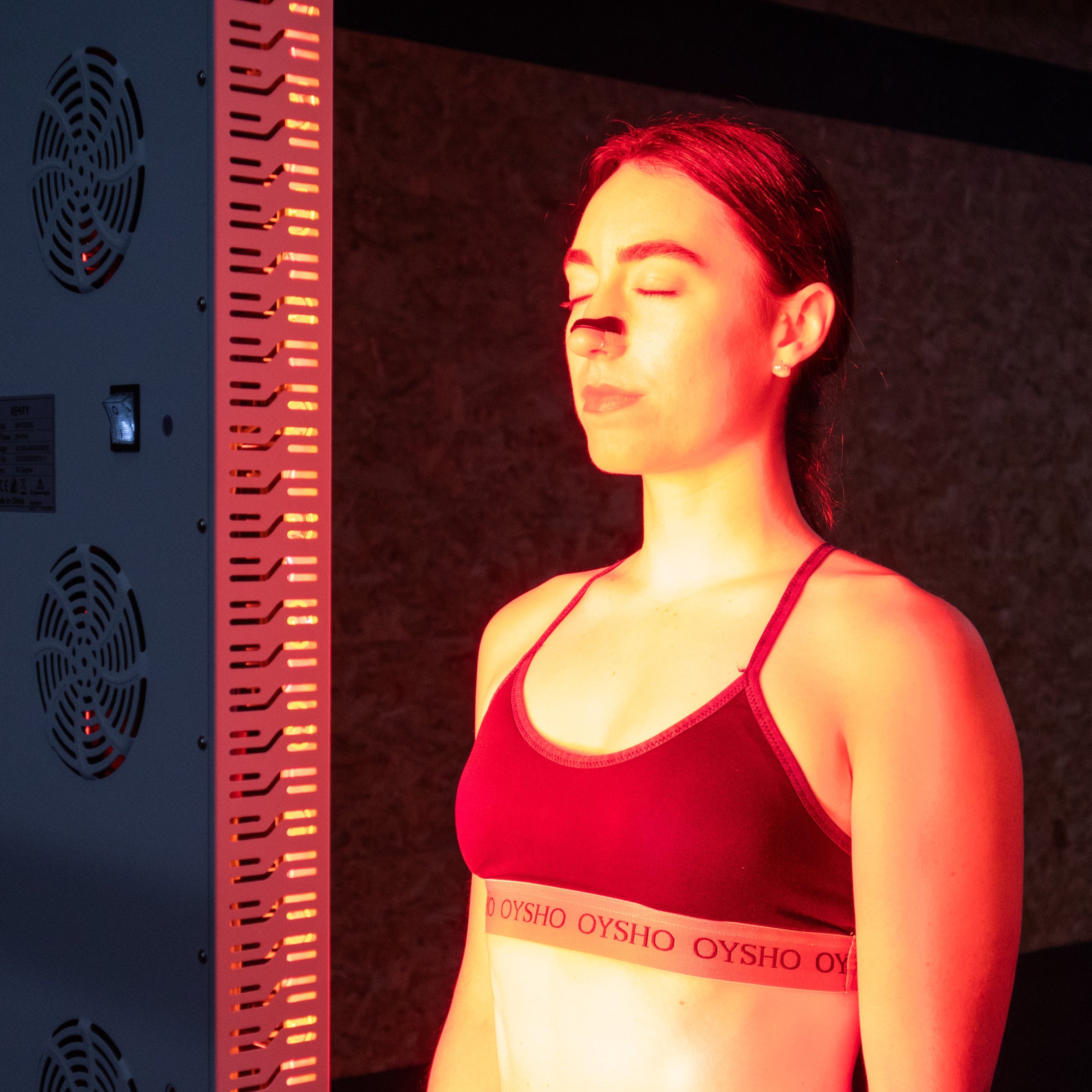 Woman wearing a Resty magnetic nasal strip included in the Magnetic Deep Sleep Bundle